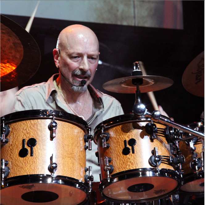 Steve Smith plays the drums.