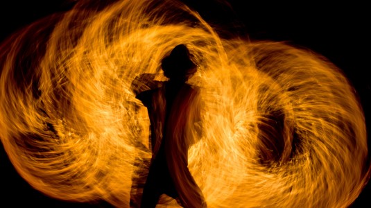 A man twirling fire.
