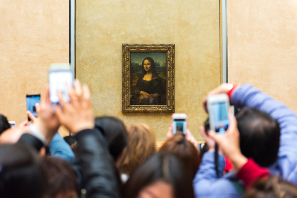 Spectators take photos of Leonardo da Vinci’s “Mona Lisa” at the Louvre Museum in Paris, France.