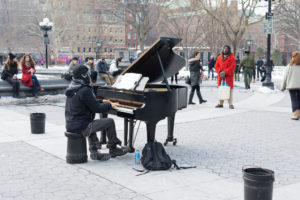 A pianist playing in Washington Square Park, located in Manhattan.