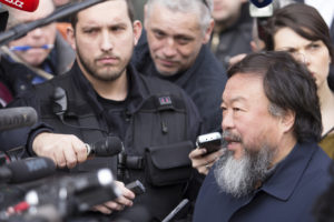 A photo of Chinese artist Ai WeiWei taking questions from the press.